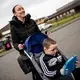 Leanne Quigley, of Possilpark, a neighborhood in Glasgow, pushes her son David Crichton, 7, back home after leaving Possilpoint Community Centre. Image by Michael Santiago. United Kingdom, 2019.