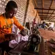 Lebron Baroka, an 18-year-old from a militia-controlled town called Bangassou, works as a tailor at Chinko. Image by Jack Losh. Central African Republic, 2018.