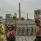 Workers carry bricks after they are formed and stack them in preparation for firing. Roughly one million people are employed in Bangladesh’s brickmaking facilities, which generate nearly 60 percent of the particulate pollution in Dhaka. Image by Larry C. Price. Bangladesh, 2018.