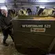 Christy Spexet moves a feed dispenser. Image by Mark Hoffman/The Milwaukee Journal Sentinel. USA, 2019.