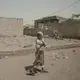 In this Feb. 12, 2018, photo, a girl walks alone on a street in al-Khoukha, Yemen. Since the Saudi-led coalition began its bombing campaign against the rebels in 2015, the U.N. estimates that some 10,000 civilians have been killed. Millions need humanitarian assistance and have been forced to flee their homes. Image by Nariman El-Mofty. Yemen, 2018. </p>
<p>