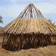 A grass-thatched house being completed in Walumbe village. According to Busoga Forestry Company, no permanent structures are allowed in the forest reserve. Image by Annika McGinnis. Uganda, 2019. </p>
<p>