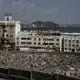 This Feb. 17, 2018, photo shows the Mercedes Benz building damaged in Aden, Yemen. Once a peg in a thriving commercial center that sprang up under colonial rule, the dealership sits empty and pockmarked with bullet holes. Its damaged sign now stands over bay windows boarded up by people sheltering inside. With the war still raging, nothing is being rebuilt. Image by Nariman El-Mofty. Yemen, 2018.</p>
<p>