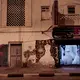 This Feb. 15, 2018, photo shows war damage outside Lelte boutique for wedding dresses on a street in Aden, Yemen. Despite the country’s ongoing war, wedding boutiques are open late into the night, salesmen inside chewing stimulant qat leaves to pass the time. “Women come in and look at some dresses, but they are expensive for people now, so it’s hard to sell,” said one clerk. Image by Nariman El-Mofty. Yemen, 2018. </p>
<p>