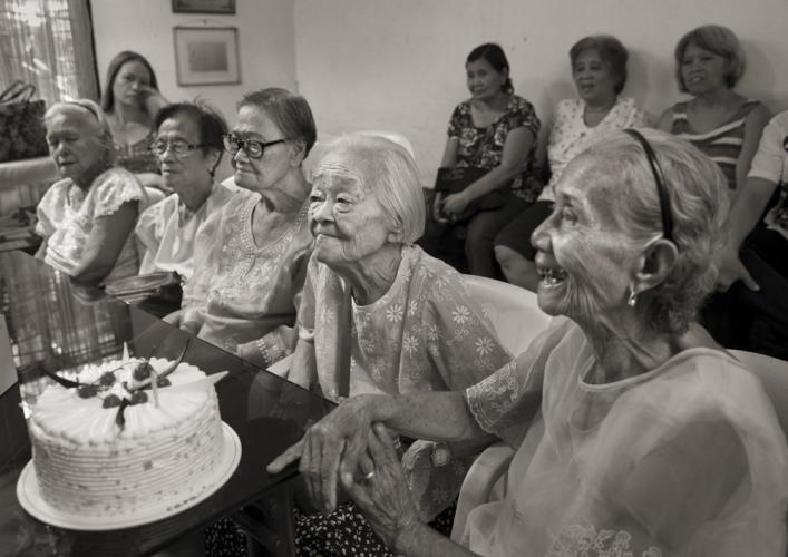 Women gather around cake
