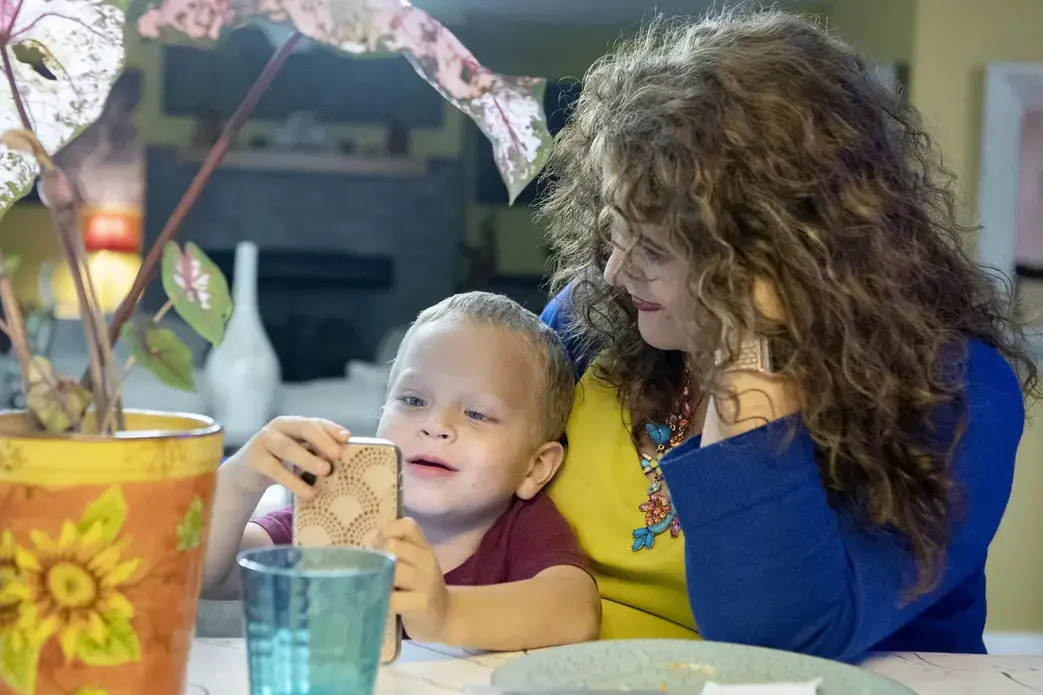 Crystal Camacho plays a game on her phone with her son, Elias, 4, at the kitchen table of their home in Swannanoa on June 30. Image by Angeli Wright/Asheville Citizen Times/North Carolina News Collaborative. United States, 2020.</p>
<p>