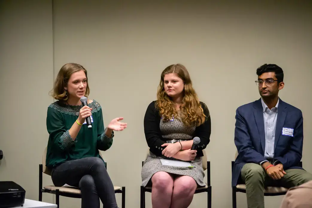 Catherine Cartier (Davidson College) responds to an audience question during the 'Impact of Religion' Q&A session alongside fellow panelists Kaitlyn Johnson (Georgetown University) and Nikhil Mandalaparthy (University of Chicago). Image by Nora Moraga-Lewy. United States, 2019.