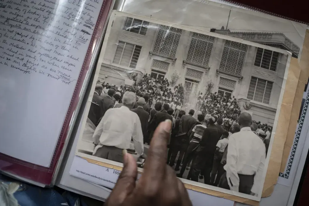 Johnson points to an old photo of a gathering after the death of Rev. Martin Luther King Jr., during an interview with The Associated Press, in Meridian, Miss. Image by Wong Maye-E / The Associated Press. United States, 2020.