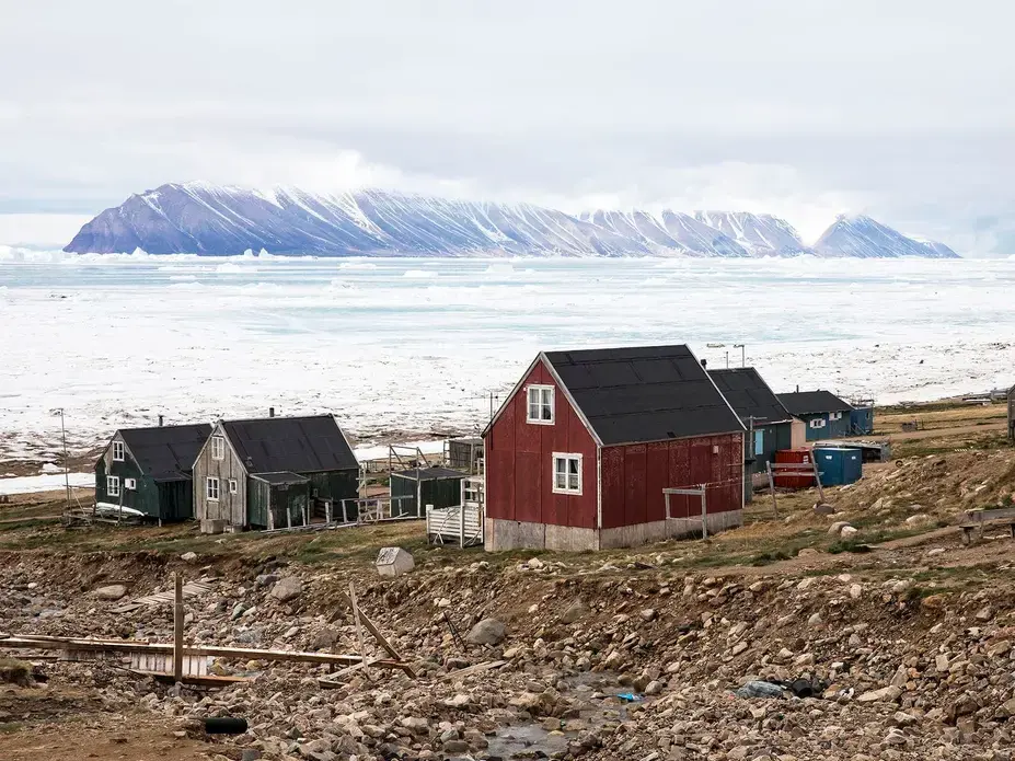 Many of the town’s inhabitants live in permafrost areas, and their homes were built on frozen ground. But as the permafrost has thawed, the ground has become less capable of supporting their homes, which can become dangerous to inhabit. Greenland, 2019. Image by Anna Filipova. 
