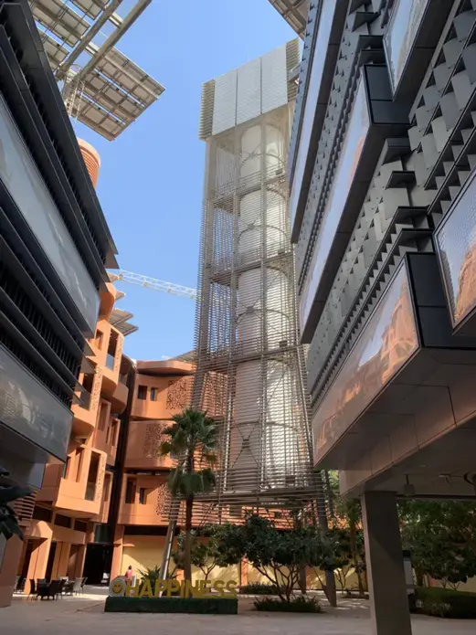 The Masdar Wind Tower captures winds and drives them down to the city’s main level to promote cooling. Solar Panels hang over the edges of buildings in the city to generate energy while shading the streets. Image by Anna Gleason. United Arab Emirates, 2019.