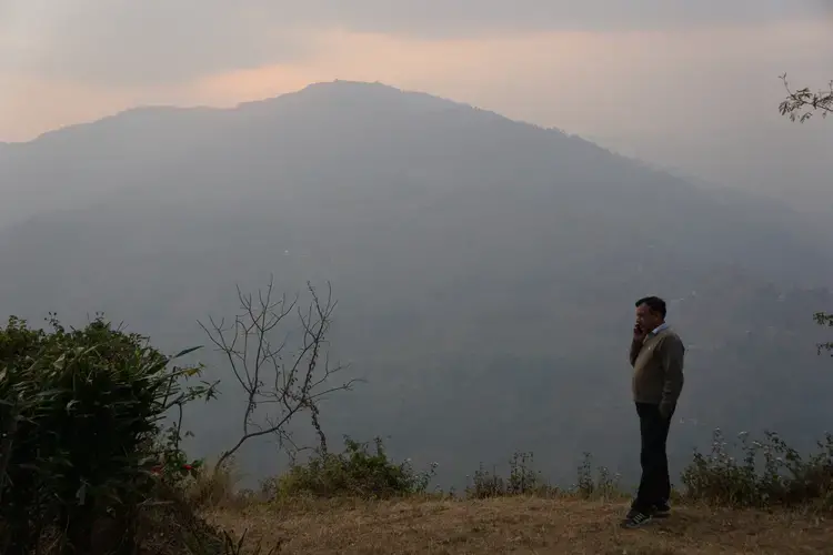 Anil Bansal, overlooking part of the Ambootia Estate that meets up with the Teesta River at sundown. Image by Esha Chhabra. India, 2017.