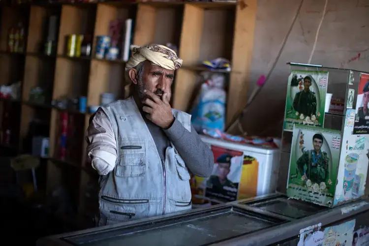 Bander Asadani, a shopkeeper who was one of the rescuers after the first strike and who lost his arm during the second wave of strikes. Image by Tyler Hicks/The New York Times. Yemen, 2018.