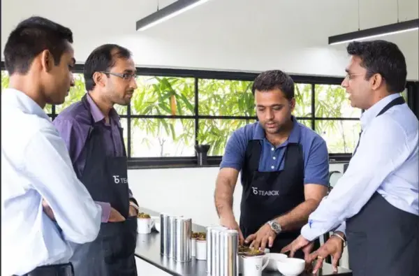 Gopal Upadhayay (third from left) with founder of Teabox, Kaushal Dugar (far right), testing Darjeeling teas. Image courtesy Teabox.