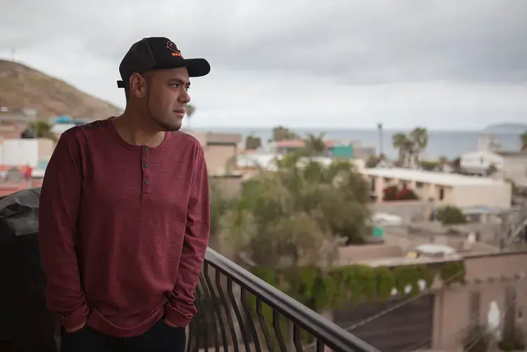 Miguel Pérez looks out over Tijuana from his balcony. Mexico, 2019. Image by Erin Siegal McIntyre. 