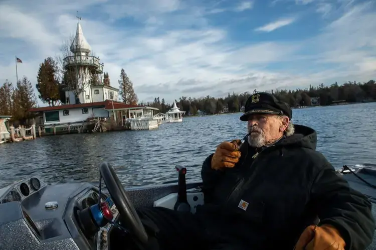 Kenneth 'Captain Ken' Kloster Sr. pilots his boat to his home on Dollar Island in Les Cheneaux Islands on Lake Huron in the Upper Peninsula of Michigan on Nov. 23, 2019. He bought the island in 1981 right before record setting high water levels of 1986. Image by Zbigniew Bzdak / Chicago Tribune. United States, 2020.