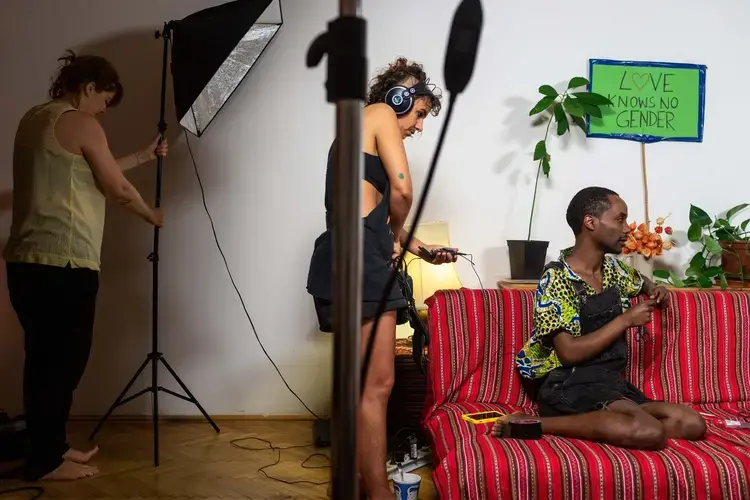 Faris (right), 35, from Addis Ababa, Ethiopia identifies as non-binary, and now lives in Vienna, Aurstia, where he was granted political asylum in July 2017. As part of a series of online videos about LGBTI+ rights in Amharic, Faris chats with his co-host Noël during a break in filming in his living room. Image by Bradley Secker. Austria, 2020.