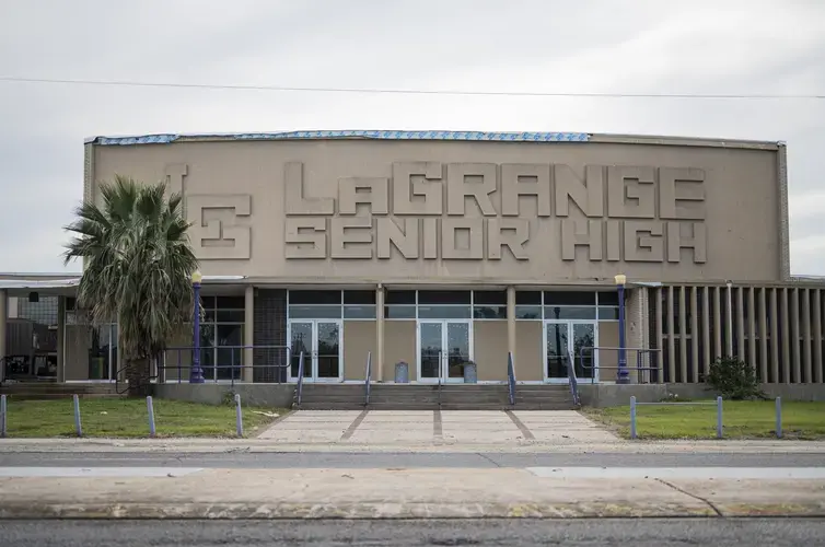 LaGrange High School remains damaged months after back-to-back Hurricanes Laura and Delta passed through the state. Many students and teachers are still displaced, living with relatives or in hotels paid for by the state. Image by Katie Sikora. United States, 2020.<br />
