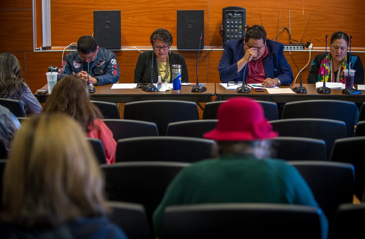 Navajo Nation council members pray at the beginning of a uranium public hearing sponsored by the Navajo Nation Council at Diné College in Shiprock, N.M. Image by Mary F. Calvert. United States, 2020.
