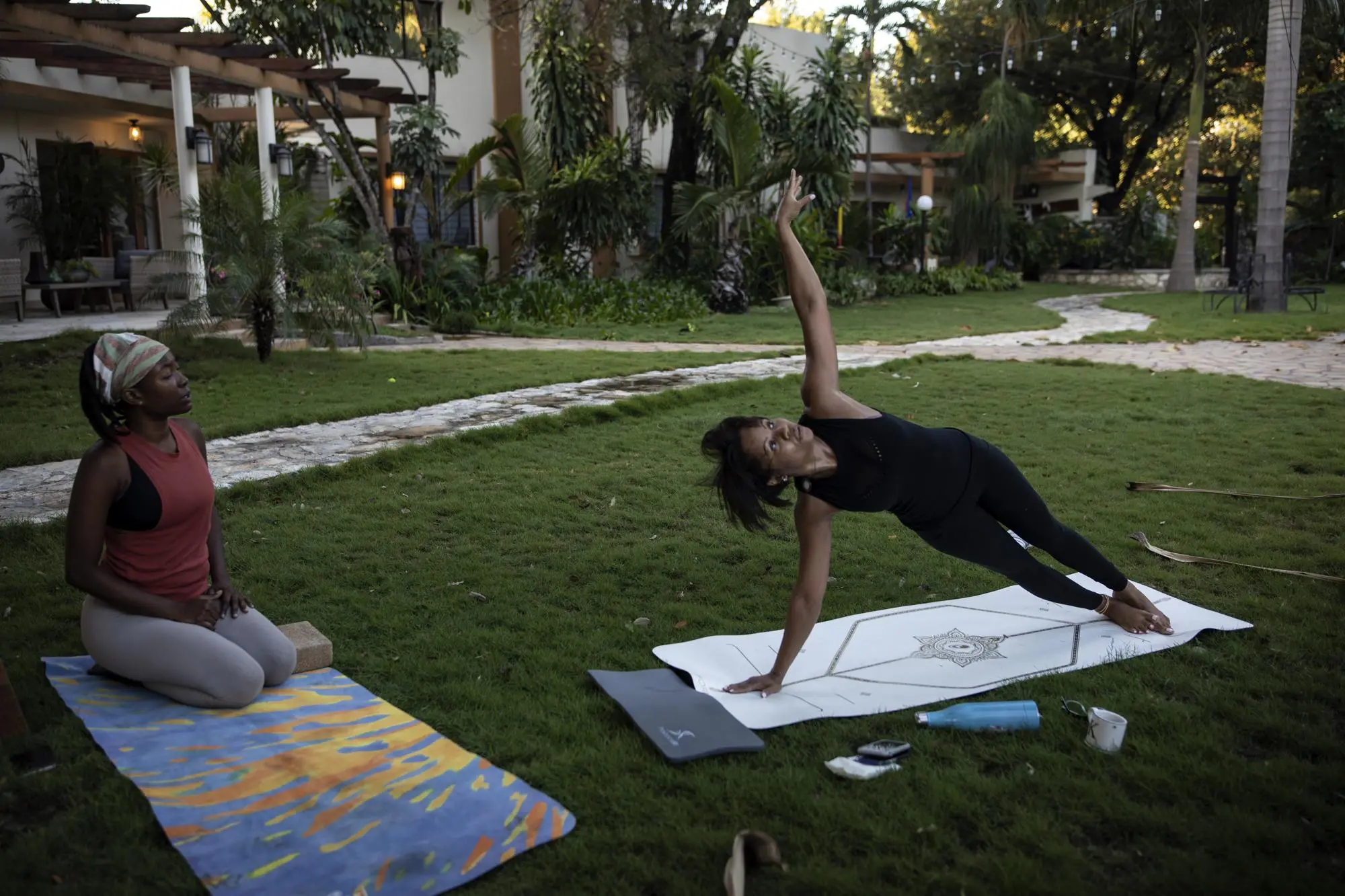A businesswoman does yoga in her yard