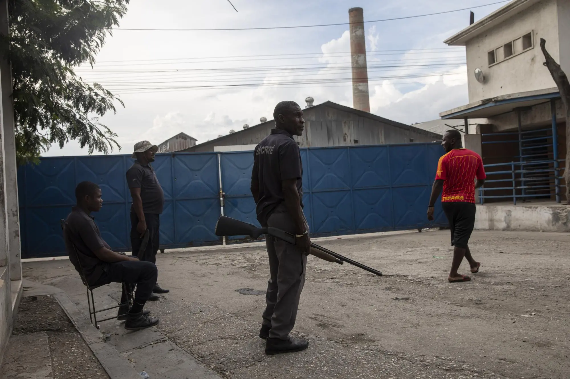 Men guard a industrial park in Port-Au-Prince
