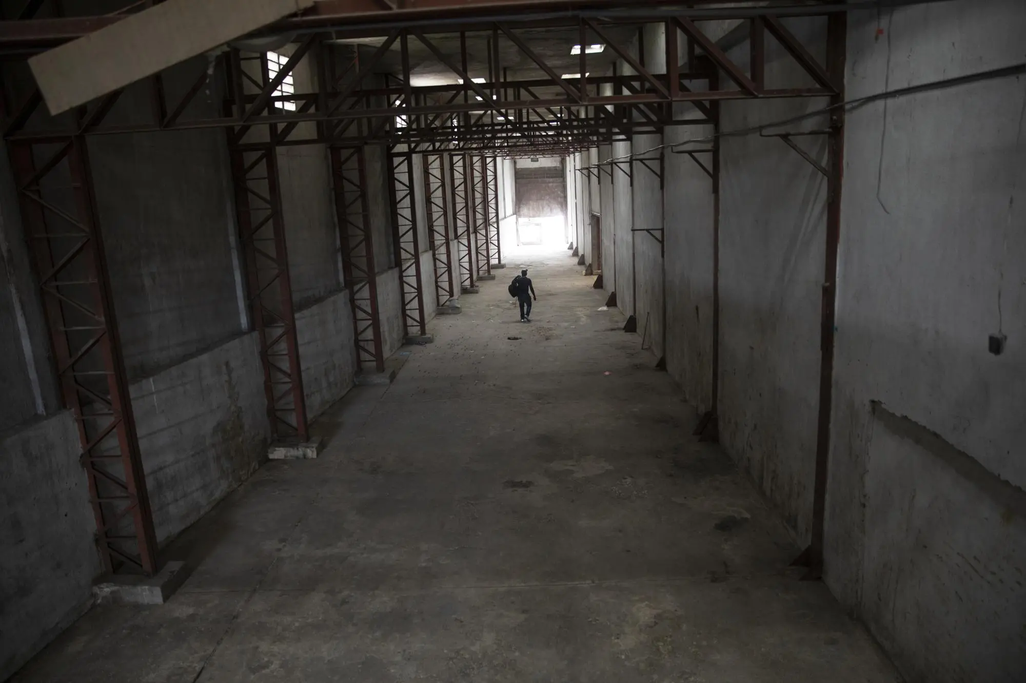 Man walks through empty warehouse