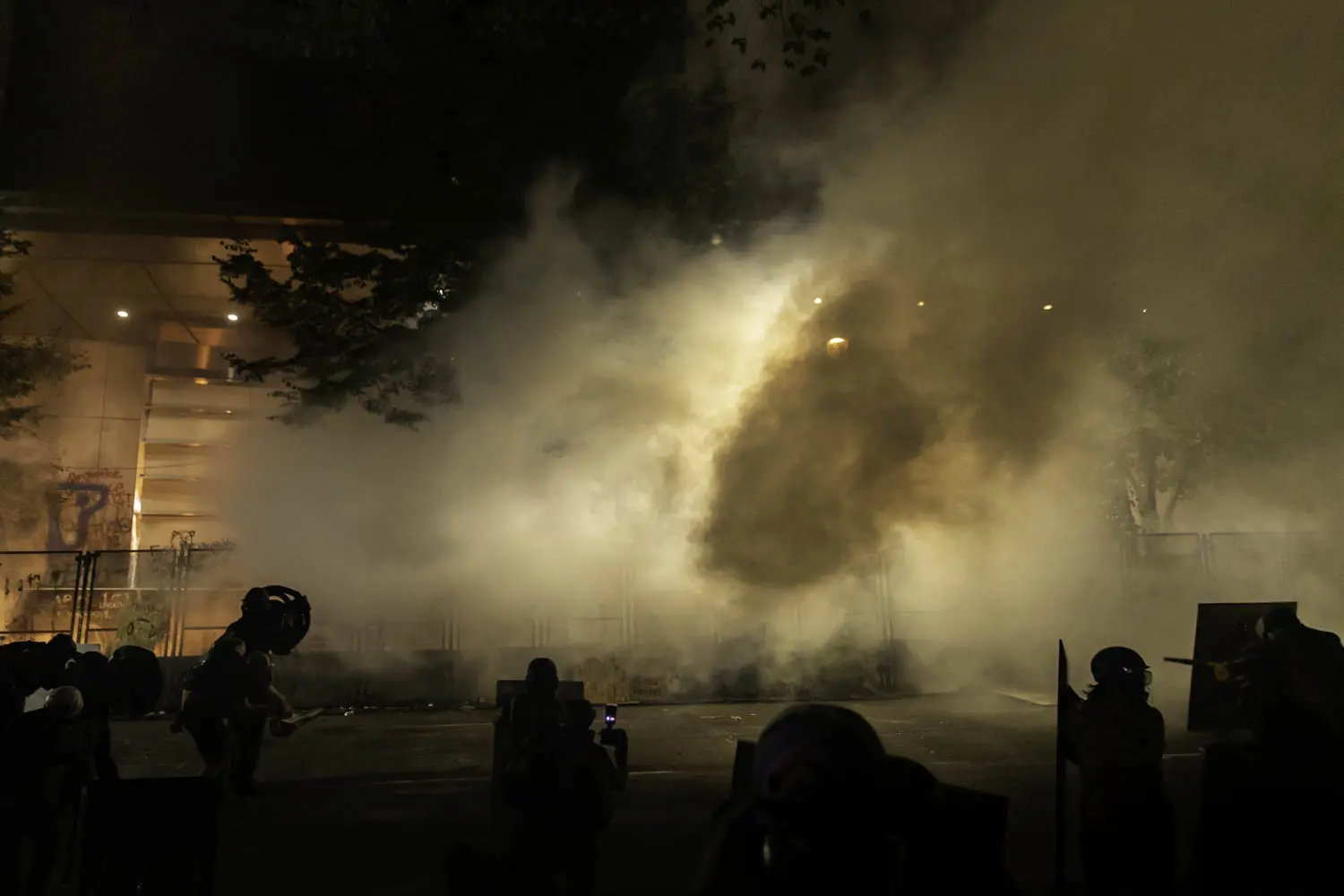 Tear gas fills the night air.