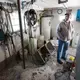 Bruce Drinkman looks around the milk house that needs to be cleaned and painted. Image by Mark Hoffman. United States, 2019.